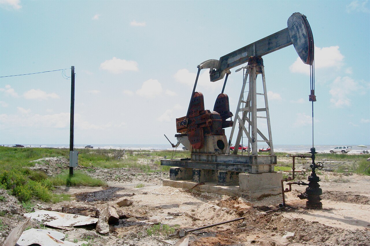 Oil pumpjack at work near the coast