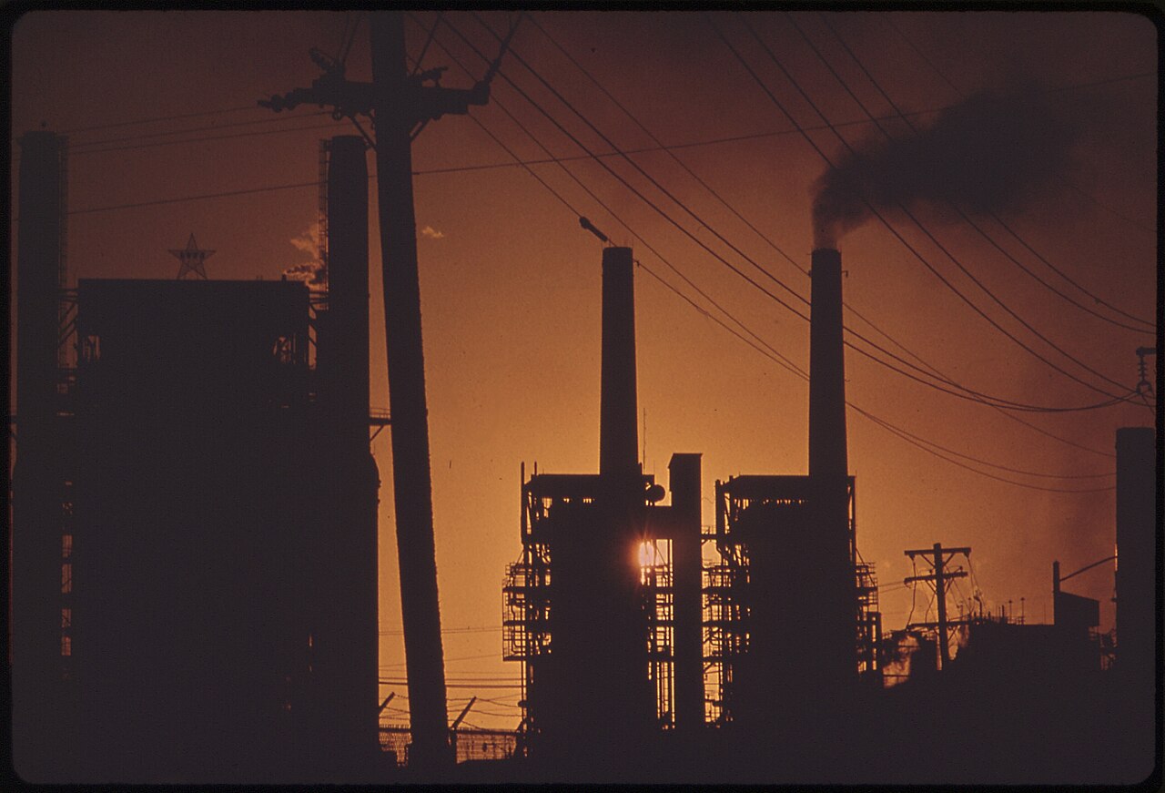 Oil refinery silhouetted at sunset